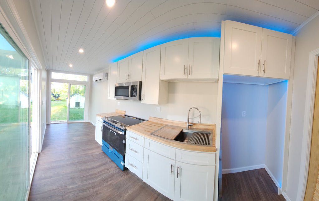 Kitchen with butcher block counters and blue accent lighting
